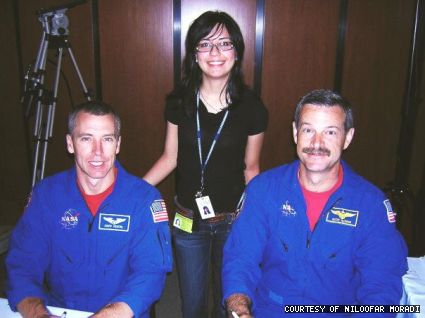 Niloofar Moradi (centre) stands between NASA astronauts Mission Specialist Andrew J. Feustel (left) and Commander Scott D. Altman. Thanks to her supervisor and mentor Edward Braunscheidel, Moradi gained access to a restricted area to meet numerous astronauts. 